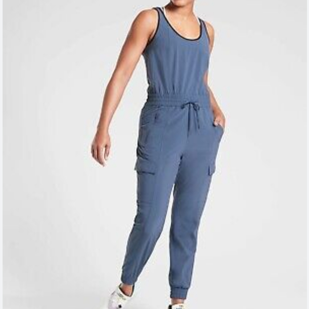 Athleta unbound jumpsuit in a pretty blue. Drawstring at the waist and it has po